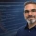 Web developer portrait with blurred HTML code in the background, representing front-end and web development fundamentals.