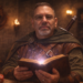 Professional portrait of Frank Jamison, a middle-aged man with short gray hair, glasses, and a neatly trimmed beard, dressed as a fantasy adventurer in a cloak and leather armor, holding a glowing spellbook in a warmly lit medieval tavern setting with candles, wooden shelves, and a sword visible behind him.