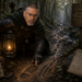 Frank Jamison portrayed as a determined D&D-inspired ranger crouching on a misty forest trail, examining tracks in the mud while holding a glowing lantern. Dressed in dark medieval ranger attire with a focused investigative expression, he follows clues through a shadowy woodland surrounded by carved signs, maps, and bug-hunting symbols inspired by The Bug Hunter’s Codex, Part VII: Following the Trail.